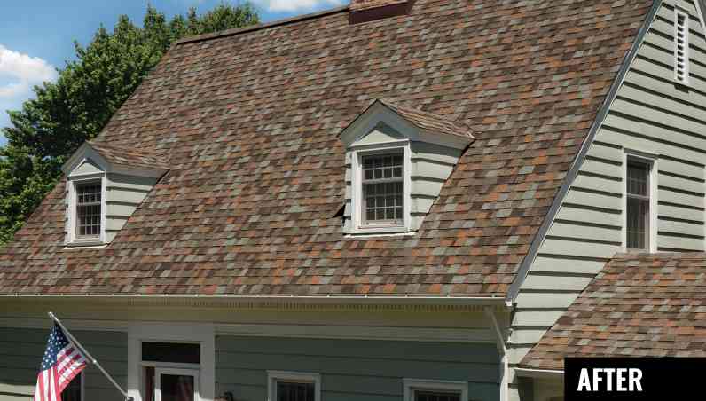 House with tan siding, two dormers with tan windows and Owens Corning Aged Copper shingles by Spokane roofing company.