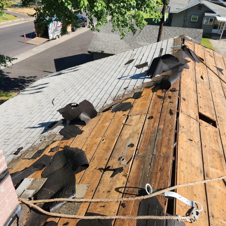 Progress shot of a partially stripped Russel Quality Roofing project.