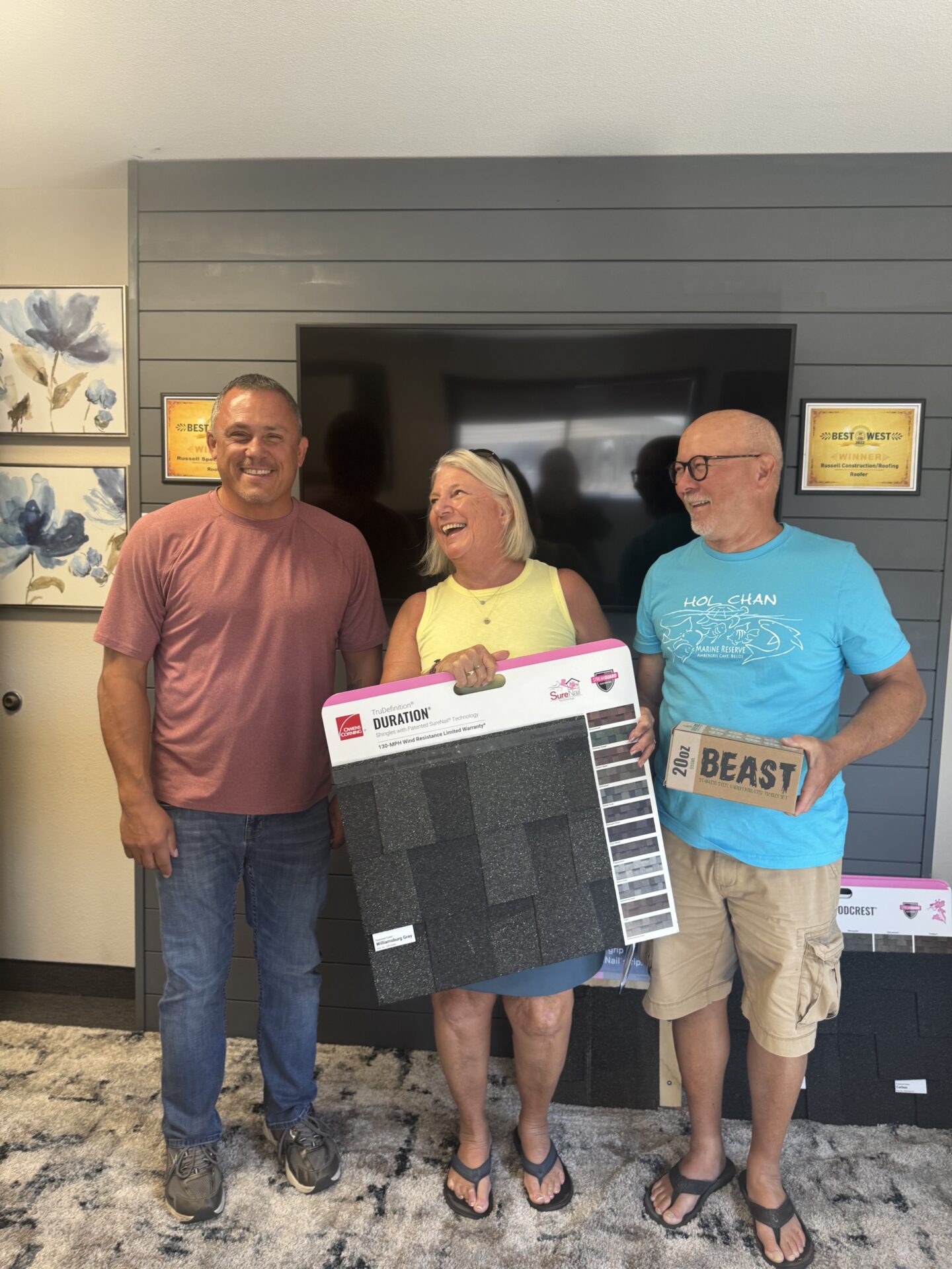 Rick Fuentes, the Project Consultant at Russell Quality Roofing, giving Don and LuAnn Wee their thank you gift for purchasing a roof through us at their Final PMT/Warranty appointment.