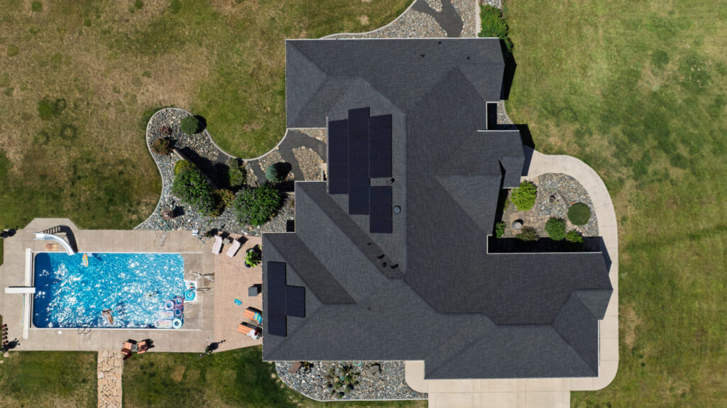 Aerial view of a new roof replacement that included solar panels