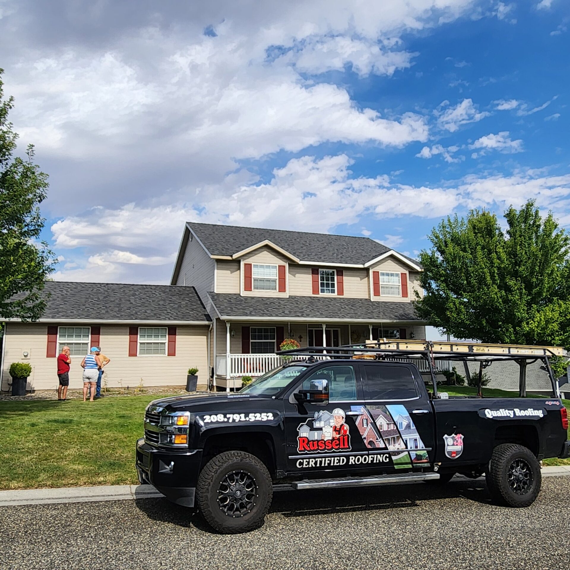 Russell Quality Roofing completing a roof replacement project in the Lewiston/Spokane area. Three men on a roof working on a roof replacement.