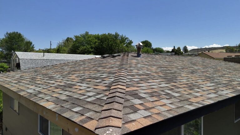 Side view shot of a completed earth toned colored roofing project done by Russell Quality Roofing