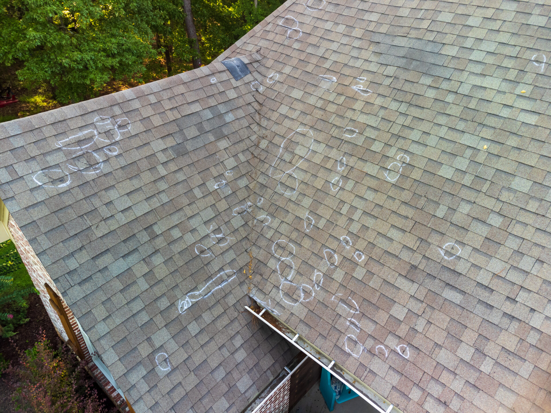 top down shot of a roof with hail damage in the Inland Northwest and chalk markings from roof inspection